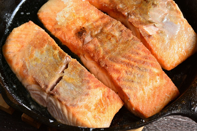 cooking salmon in a cast iron pan 