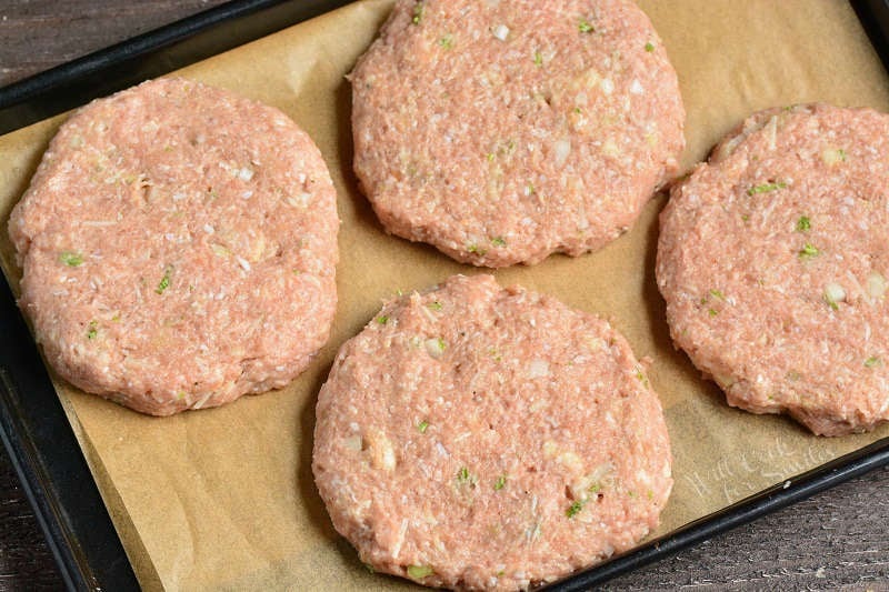 turkey burgers made into patties on parchment paper on a baking sheet 