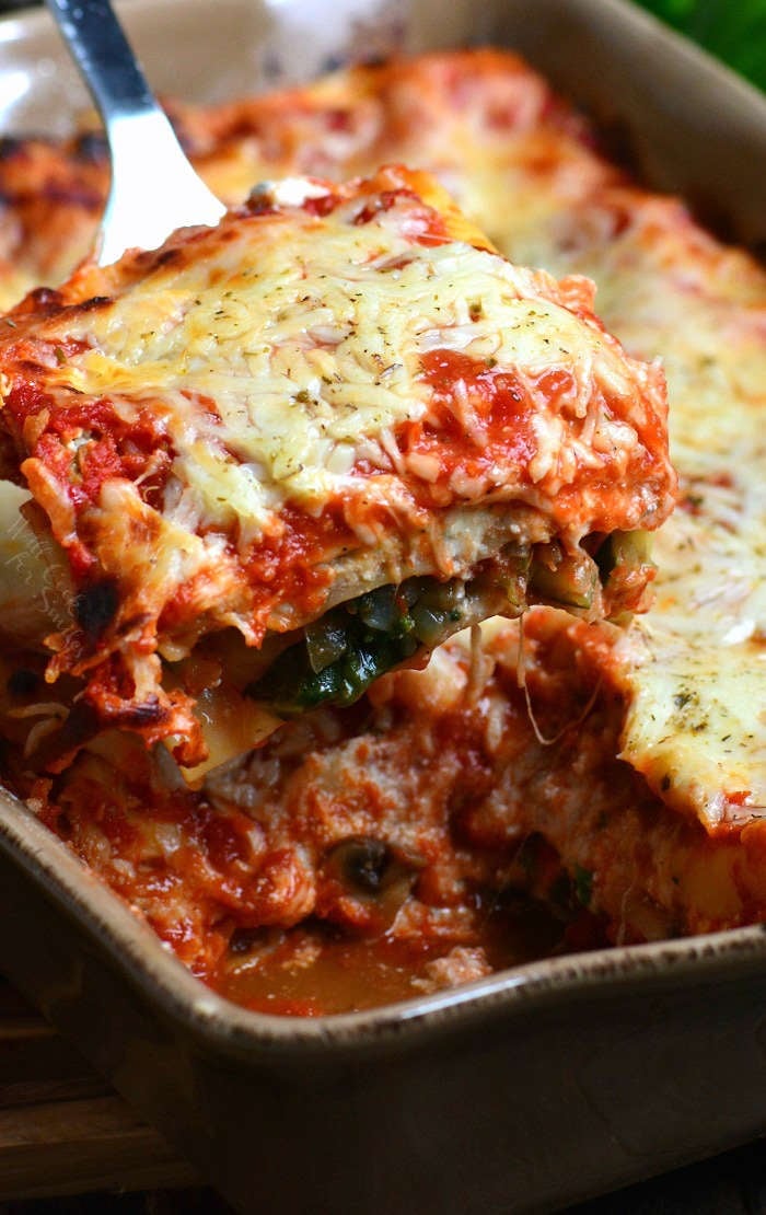 Vegetable Lasagna Recipe with zucchini with a piece cut out and being lifted by a spatula 