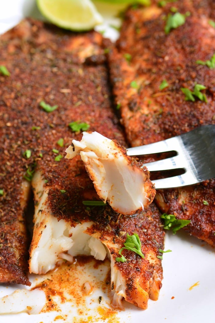 Easy Blackened Tilapia on a plate and a fork with tilapia on it 