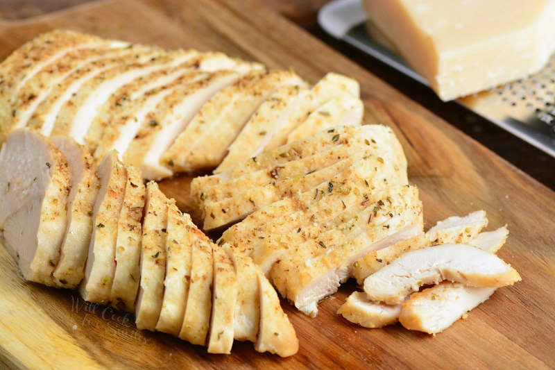 Chicken Breast sliced on a wood cutting board 