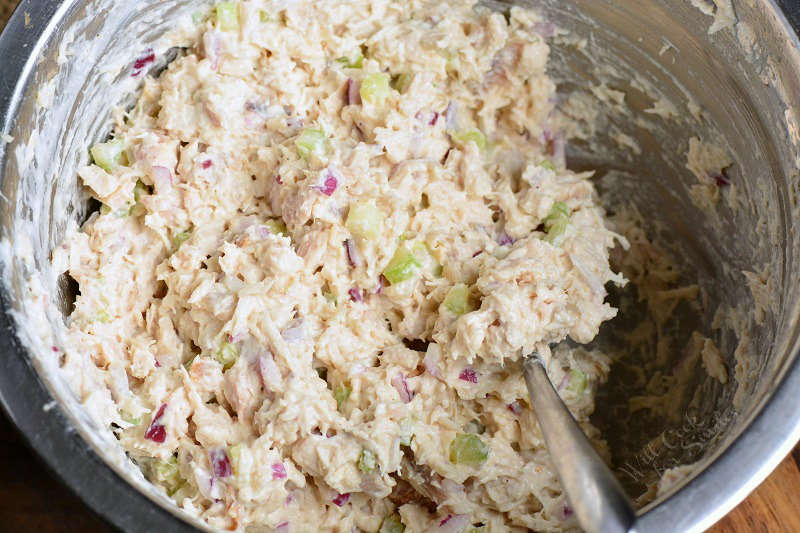 chicken salad mixed in a meatal bowl.