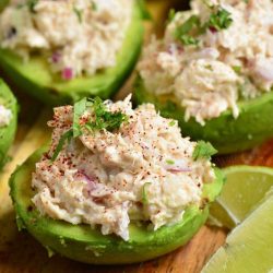 closeup of four avocadoes stuffed with chicken salad.