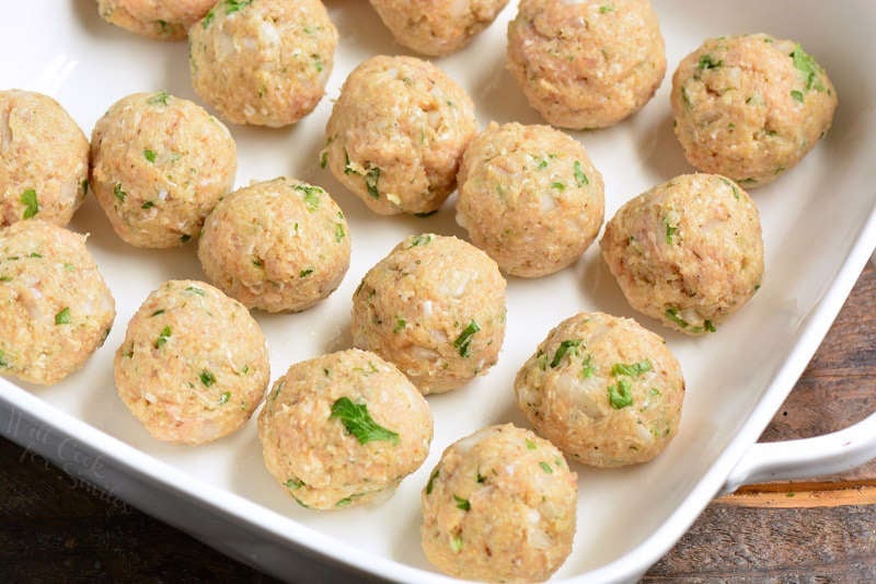 Raw chicken meatballs in a baking dish