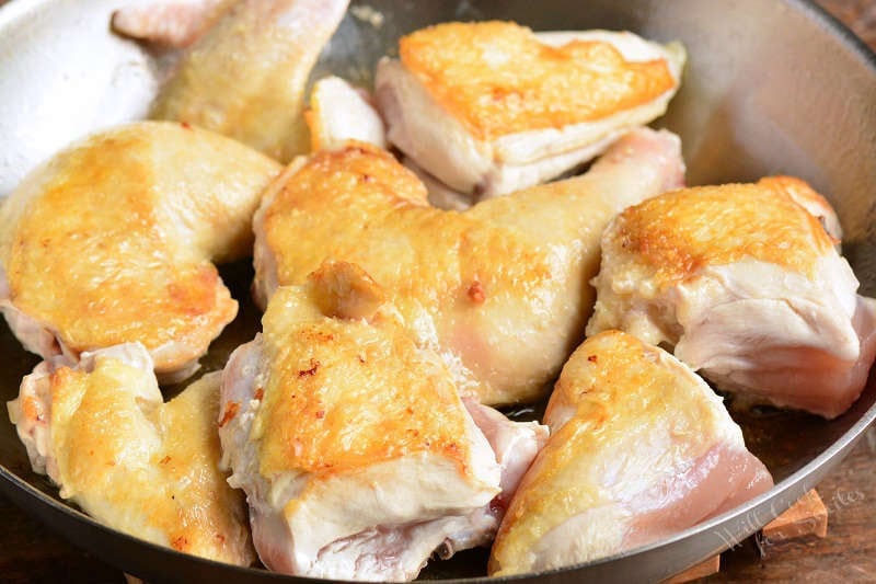 browning chicken pieces in a pan