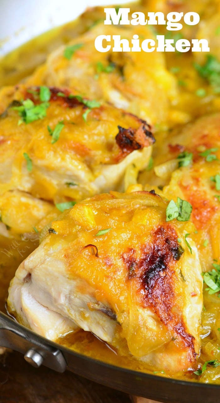 baked chicken cooked in chunky mango sauce in the pan.