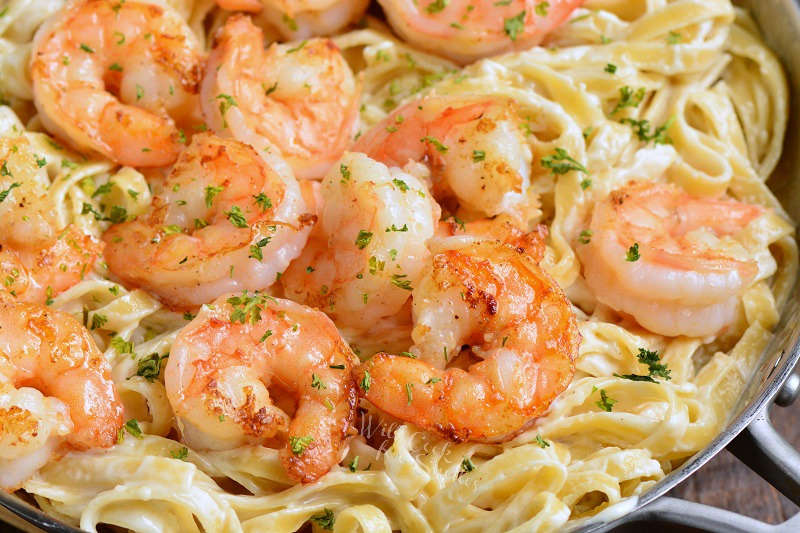 fettuccine alfredo with shrimp in a pot 