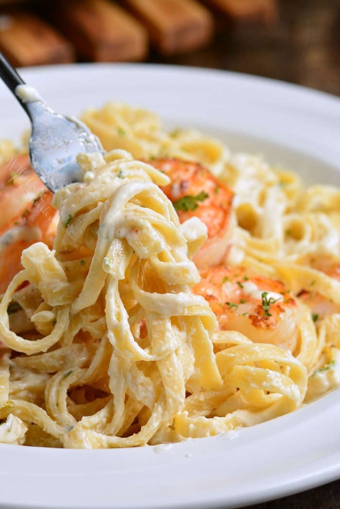 Shrimp Alfredo Pasta in a bowl and fork with pasta on it 