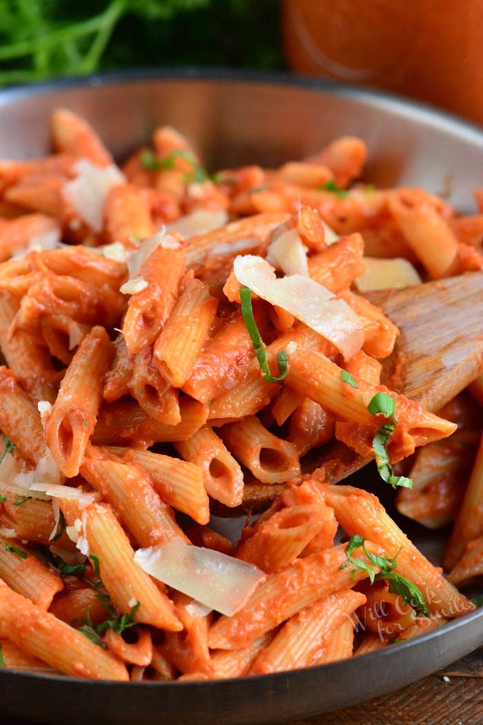penne pasta with the vodka sauce in a pan with a wooden spoon 