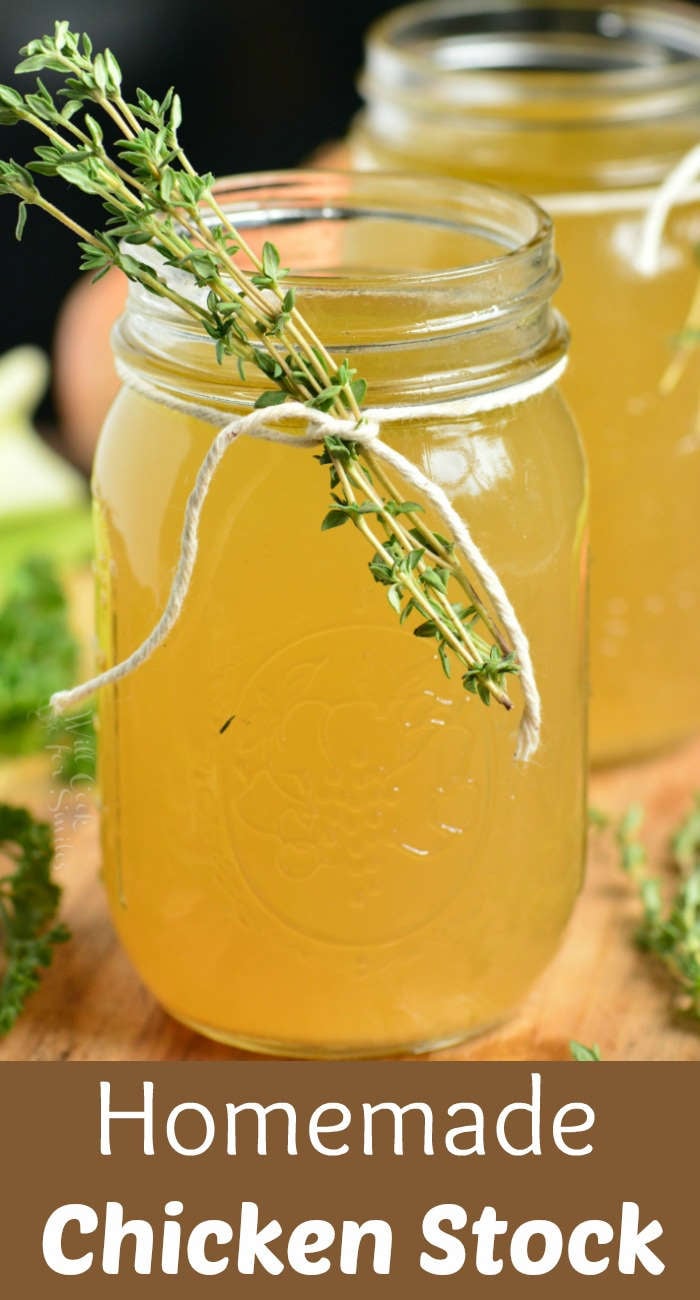 homemade chicken stock in a jar with fresh rosemary on a wooden table 