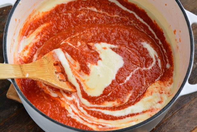 stirring in creamy roux into the blended tomato mixture of the soup