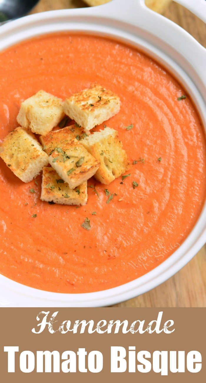 top view of creamy tomato bisque soup topped with croutons and title block on the bottom