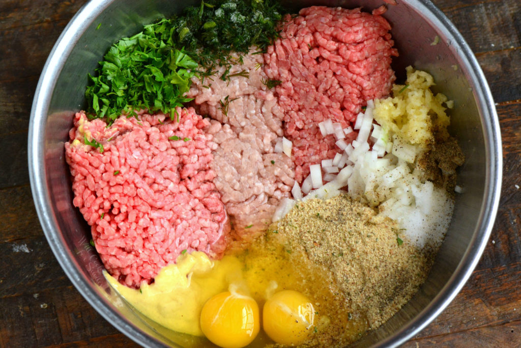 ingredients for meatloaf combined in a large mixing bowl.