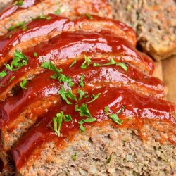 front view of sliced meatloaf on cutting board.