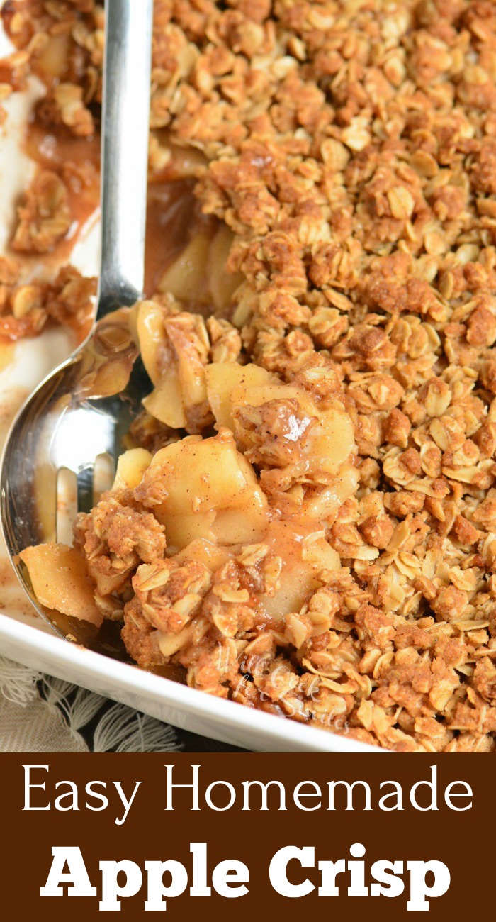 apple crisp in a baking dish being scooped out with metal serving spoon 