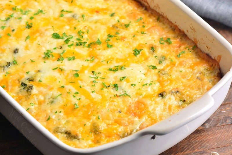 baked breakfast casserole in a baking pan on a wood cutting board 