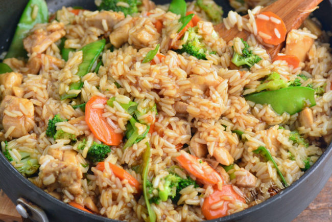 chicken teriyaki rice bowl in a pan with wooden spoon 