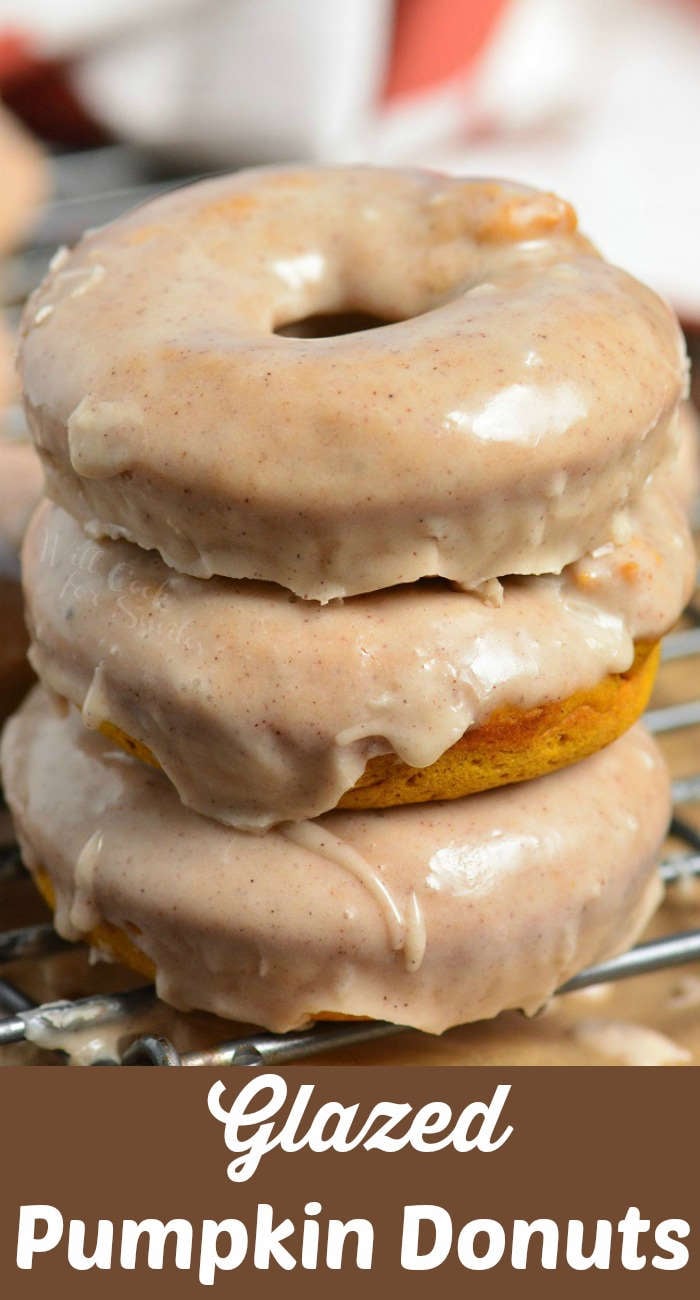 pumpkin donuts stacked up on a cooling rack 