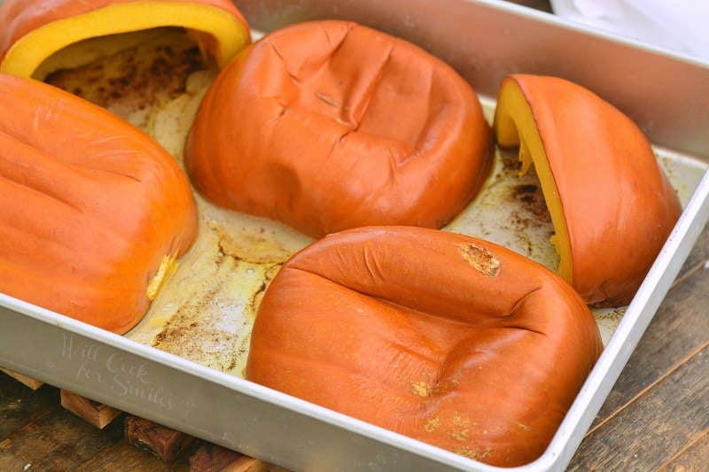 baked sugar pumpkin halves skin side up in the baking pan.