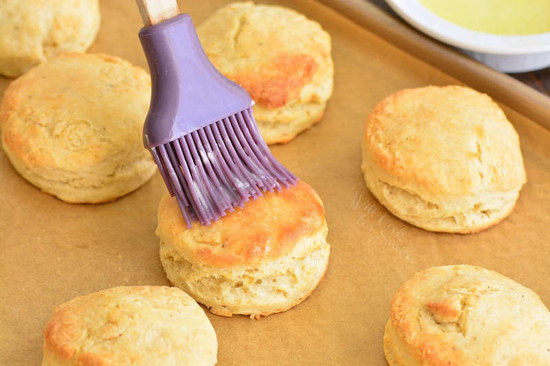 brushing baked biscuits with melted butter using silicone brush
