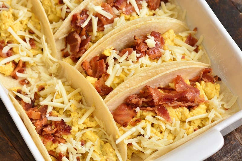 breakfast tacos before baking in a baking pan 