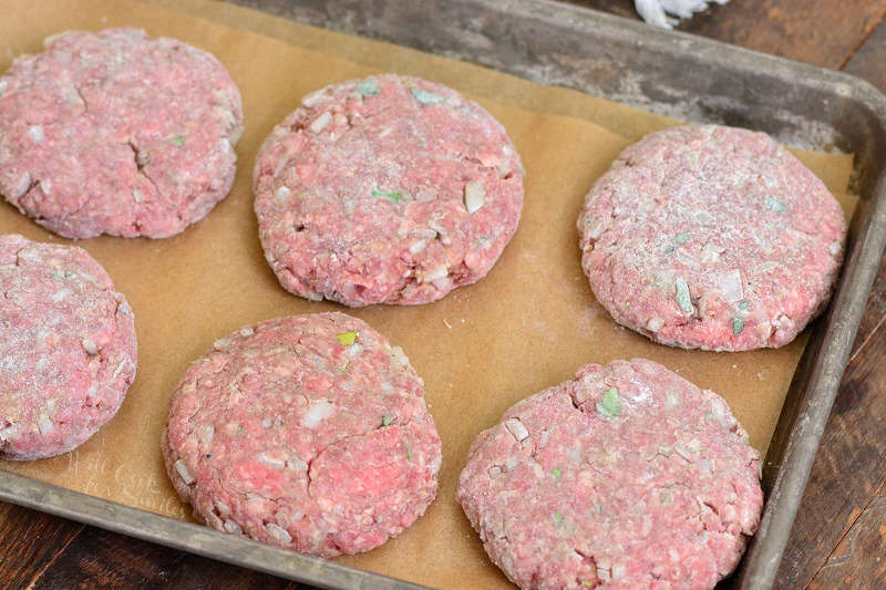 patties for saliabury steak on a parchment lines baking sheet 