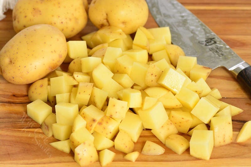 cut potatoes on a cutting board with a knife 