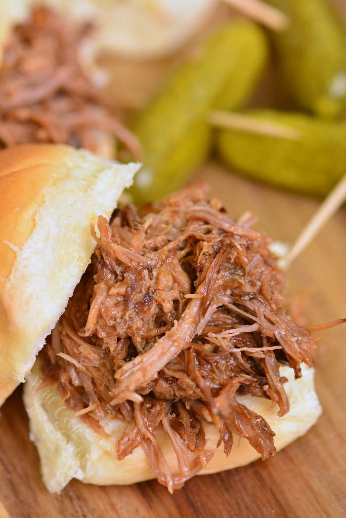 BBQ pulled pork sandwich on a wood cutting board 