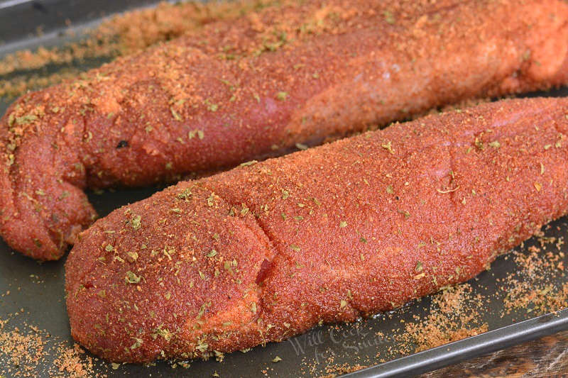 pork tenderloin coated in pork dry rub on a baking sheet 