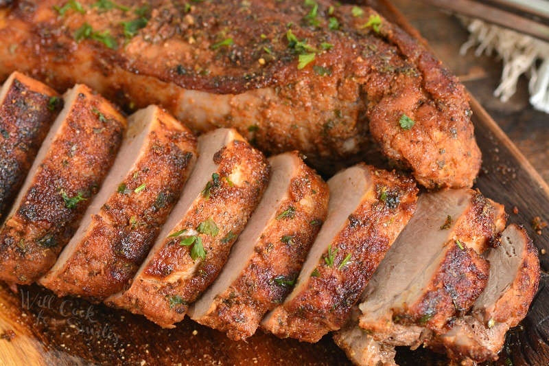 pork tenderloin cut up on a wood cutting board 