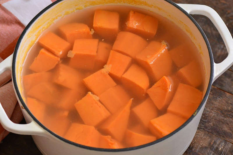 sweet potato chunks in water in a pot.