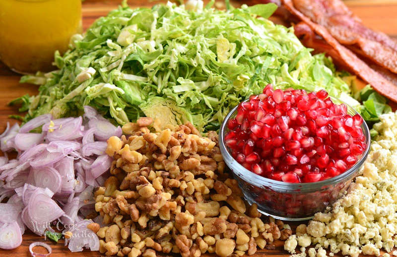 ingredients for Brussels sprouts salad on a wood cutting board 