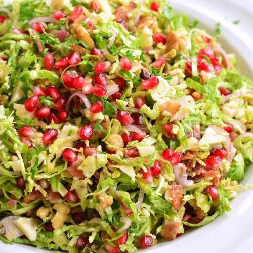 salad in a bowl with pomegranate seeds on top