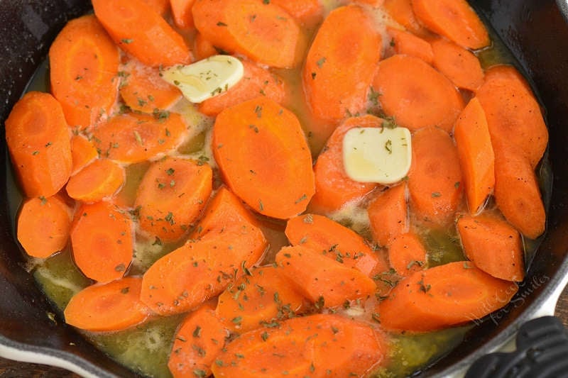 cooking butter into carrots in a cast iron skillet 