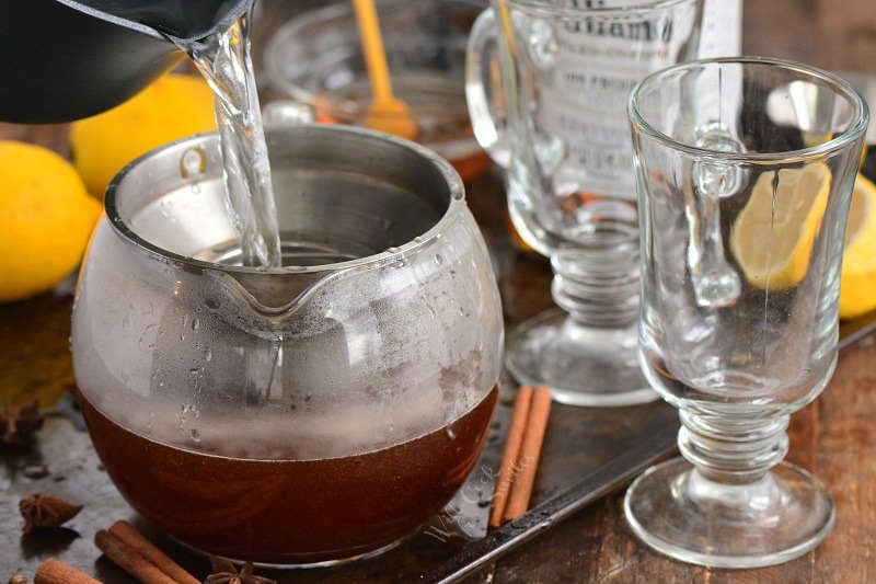 pouring hot water into glass tea pot.