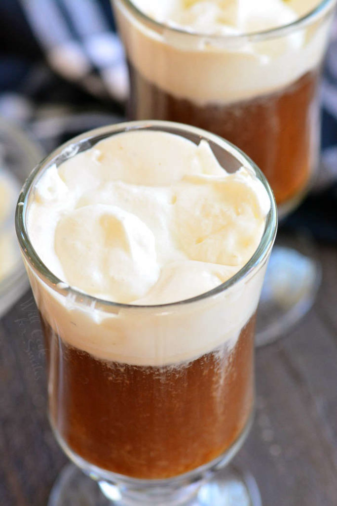 closeup of coffee cocktail topped with whipped cream.