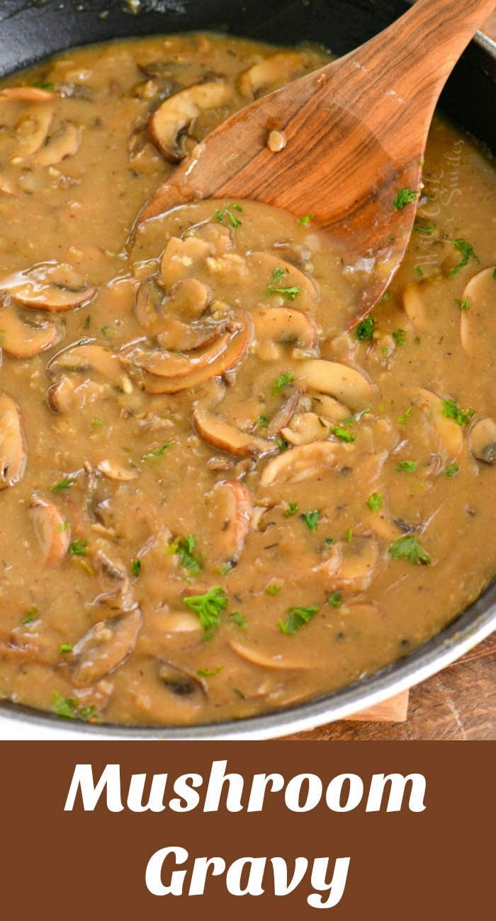 mushroom gravy in a cast iron skillet with a wooden spoon 