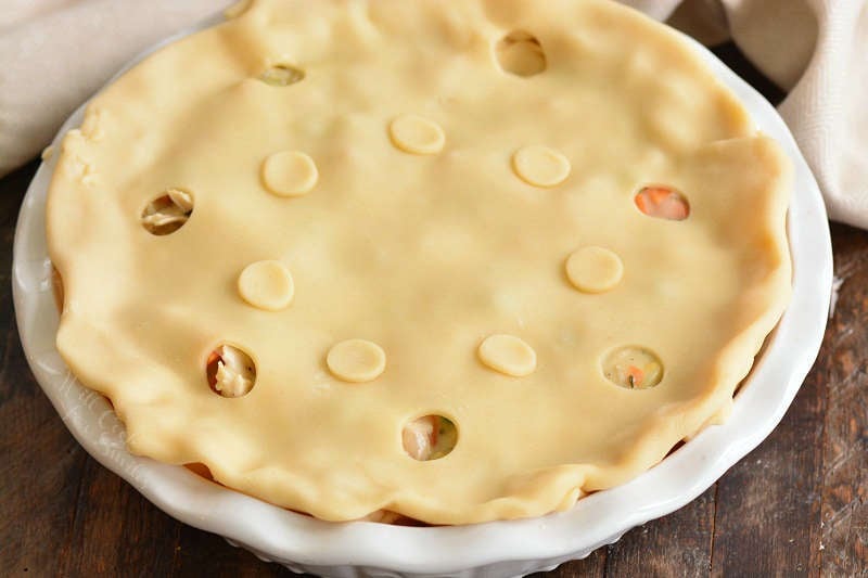 turkey pot pie before baking on a wood table 