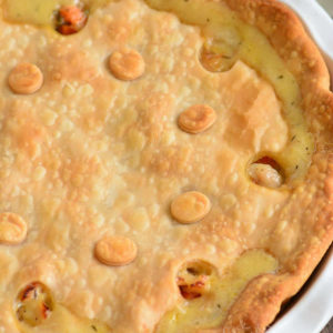 turkey pot pie in the baking dish topped with pie pastry.