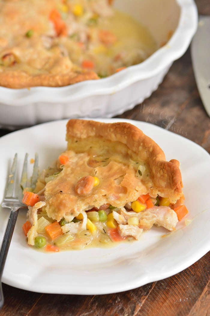 turkey pot pie slice on a plate with a fork 