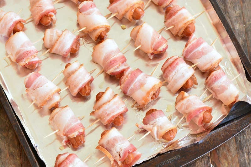 wrapped little smokies uncooked on a baking sheet 