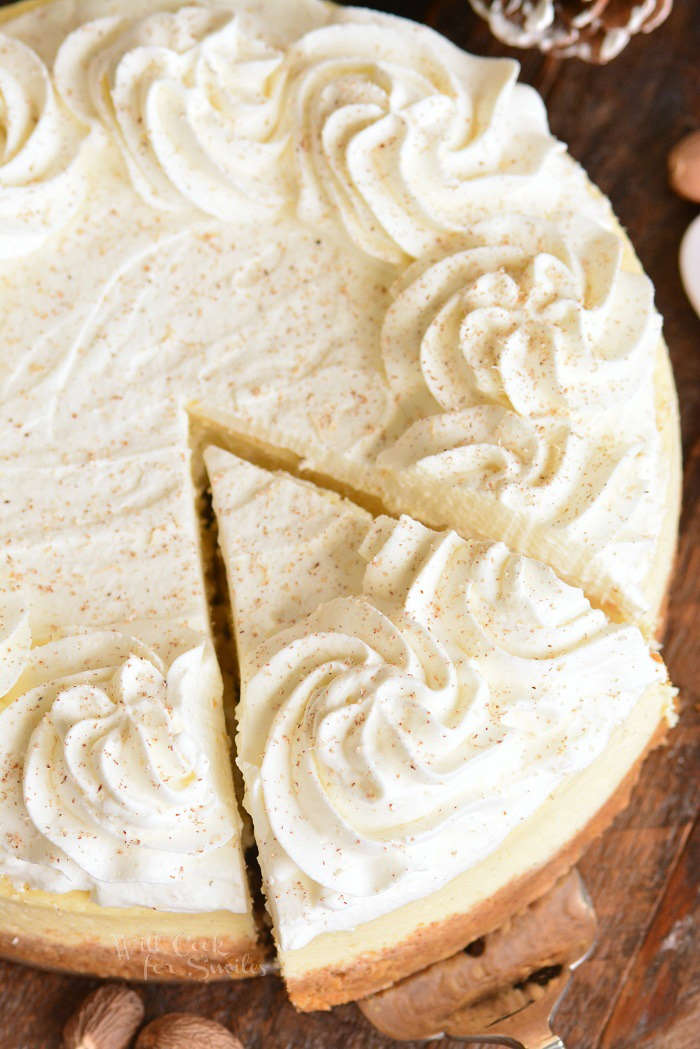 taking out slice of eggnog cheesecake