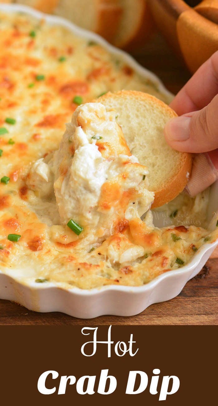 crab dip bring dipped out with a slice of bread