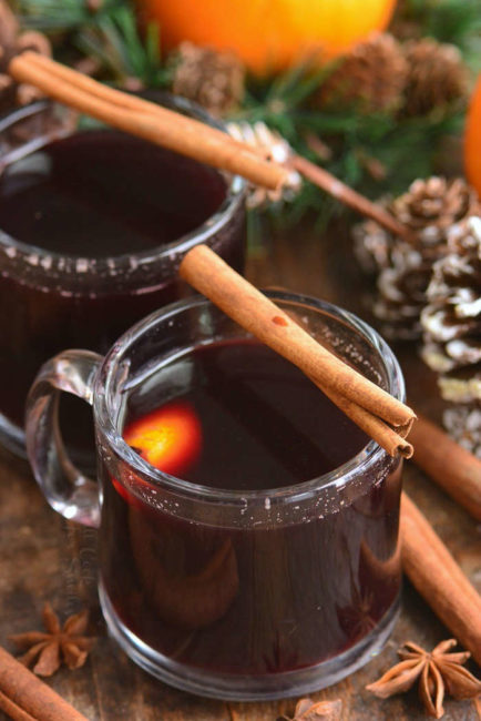 top view of mulled wine in small glass mugs with cinnamon sticks