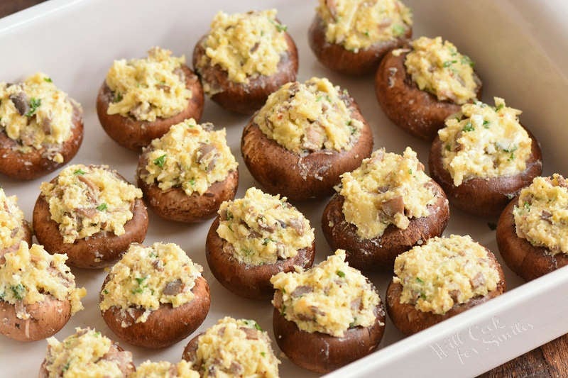 uncooked stuffed mushrooms in a baking dish