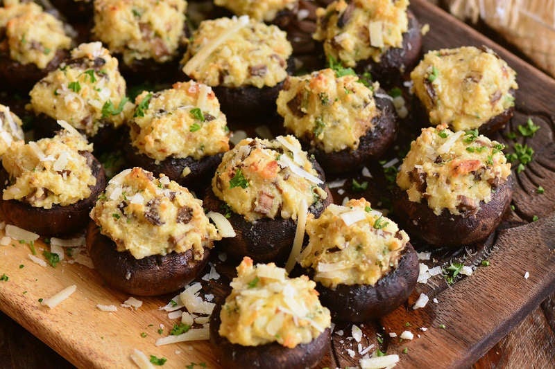 cooked stuffed mushrooms on wooden plate