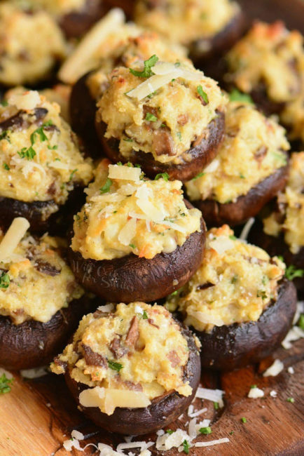 closeup of stuffed mushrooms stacked on the cutting board