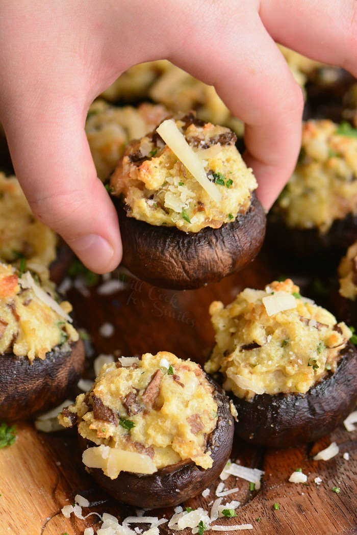 picking up a stuffed mushrooms off the plate