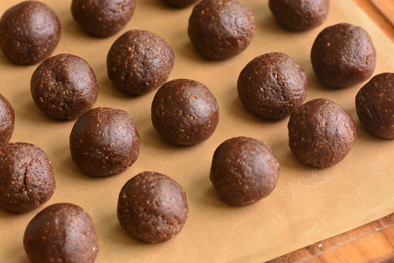 rolled rum balls on parchment paper 