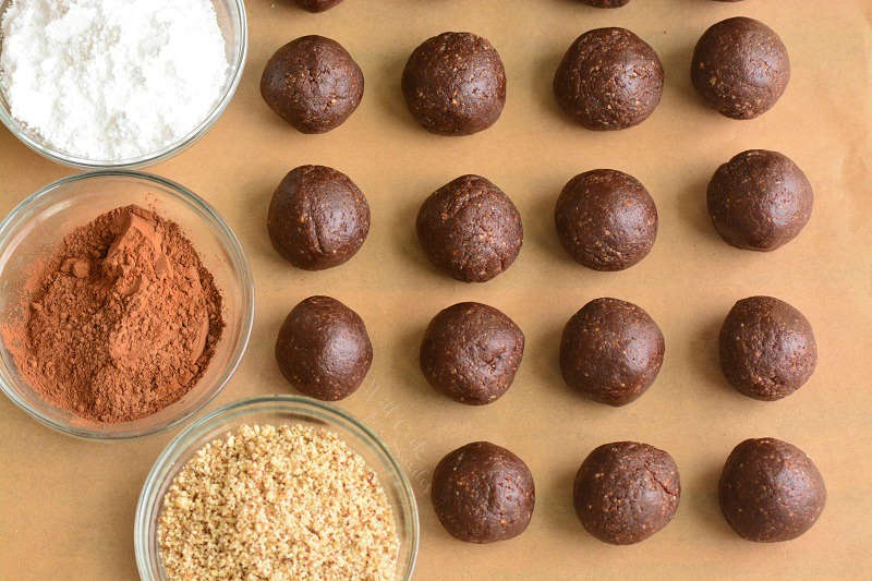 rum balls and toppings on parchment paper 